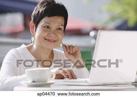 Mature woman using laptop View Large Photo Image Stock Image - Mature woman using laptop. Fotosearch