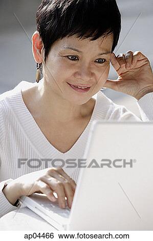 Mature woman using laptop View Large Photo Image Stock Photograph - Mature woman using laptop. Fotosearch
