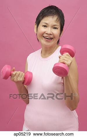 Stock Photo - Mature woman with dumbbells. Fotosearch