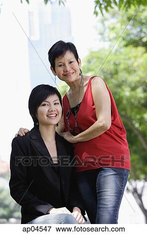 Mother and adult daughter looking at camera View Large Photo Image Stock Photo - Mother and adult daughter looking at camera. Fotosearch