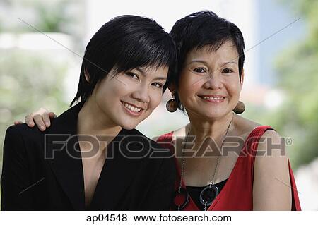 Mother and adult daughter looking at camera, head shot View Large Photo Image Stock Photo - Mother and adult daughter looking at camera, head shot. Fotosearch