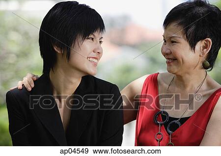 Mother and adult daughter looking at each other View Large Photo Image Stock Photo - Mother and adult daughter looking at each other. Fotosearch