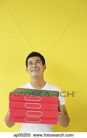 Pizza delivery person carrying a stack of pizza boxes, looking up View Large Photo Image Stock Photography - Pizza delivery person carrying a stack of pizza boxes, looking up. Fotosearch