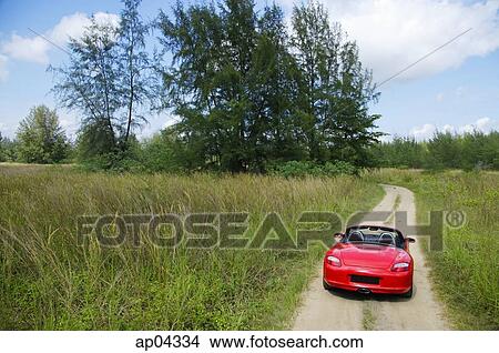 Red Porsche sports car on rural road View Large Photo Image Picture - Red Porsche sports car on rural road. Fotosearch