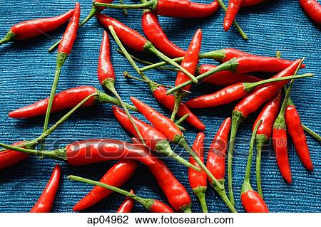 Still life of chilies against blue background View Large Photo Image Stock Image - Still life of chilies against blue background. Fotosearch