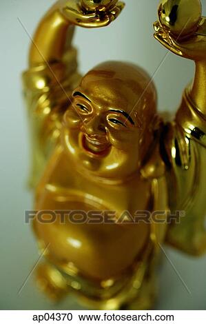 Stock Image - Still life of Gold Buddha figurine. Fotosearch