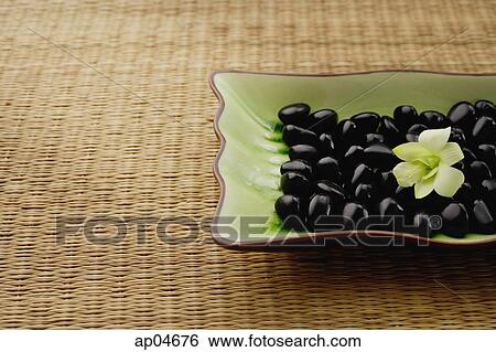 Still life of Orchid on plate of pebbles View Large Photo Image Stock Photograph - Still life of Orchid on plate of pebbles. Fotosearch