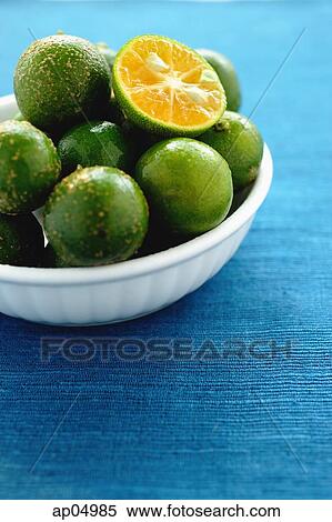 Stock Photography - Still life with bowl of limes. Fotosearch
