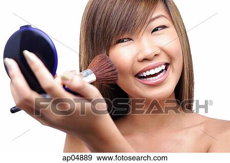 Stock Photo - Teenage girl applying make-up. Fotosearch