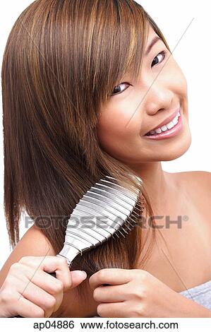 Teenage girl brushing her hair View Large Photo Image Stock Photograph - Teenage girl brushing her hair. Fotosearch