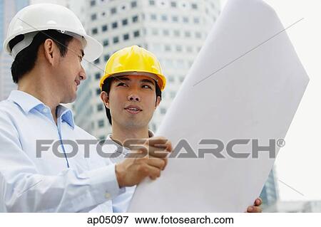 Stock Photo - Two businessmen with blueprints. Fotosearch