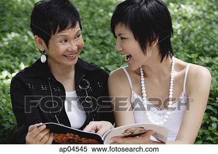 Two women with magazine View Large Photo Image Stock Photography - Two women with magazine. Fotosearch