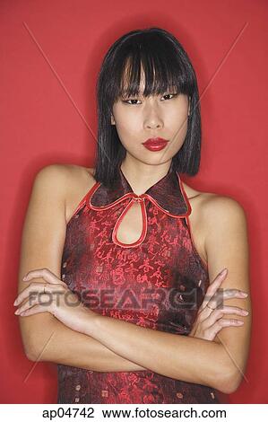 Woman against red background, dressed in cheongsam, arms crossed View Large Photo Image Stock Image - Woman against red background, dressed in cheongsam, arms crossed. Fotosearch