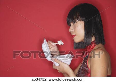 Woman against red background, eating rice from a Styrofoam container View Large Photo Image Stock Image - Woman against red background, eating rice from a Styrofoam container. Fotosearch