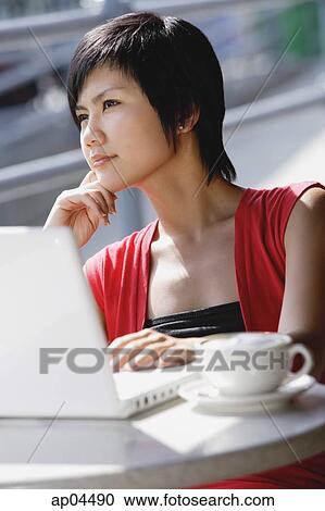 Woman at cafe with laptop View Large Photo Image Stock Image - Woman at cafe with laptop. Fotosearch