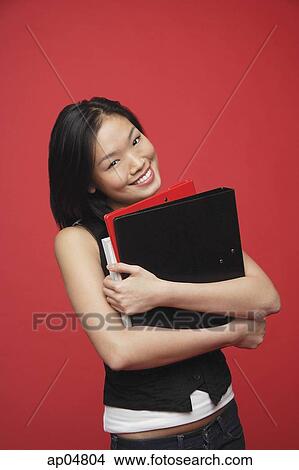 Woman carrying books, portrait View Large Photo Image Picture - Woman carrying books, portrait. Fotosearch