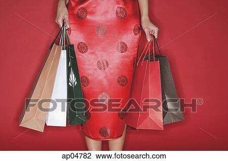Woman carrying shopping bags View Large Photo Image Stock Image - Woman carrying shopping bags. Fotosearch
