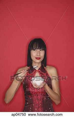 Woman dressed in red, holding bowl of rice View Large Photo Image Stock Image - Woman dressed in red, holding bowl of rice. Fotosearch