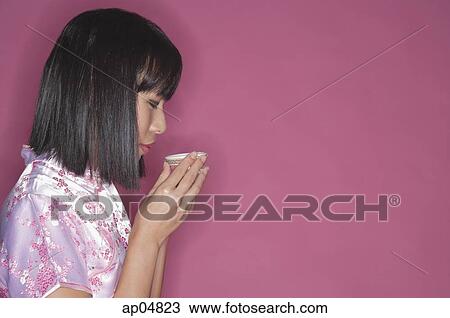 Stock Image - Woman drinking Chinese tea. Fotosearch