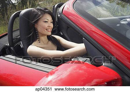 Woman driving red sports car View Large Photo Image Stock Image - Woman driving red sports car. Fotosearch