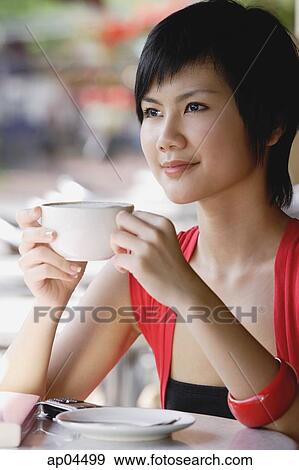 Woman having cup of coffee, looking away View Large Photo Image Stock Photo - Woman having cup of coffee, looking away. Fotosearch