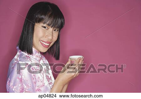 Picture - Woman holding Chinese tea cup. Fotosearch