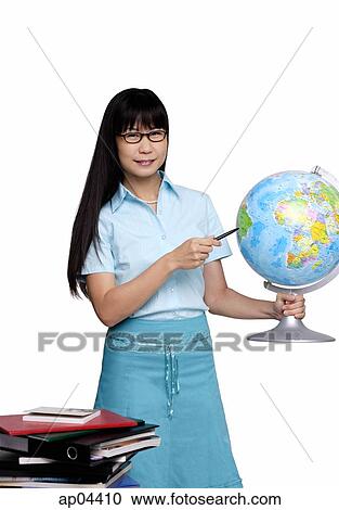 Woman holding globe and pointing at it View Large Photo Image Stock Image - Woman holding globe and pointing at it. Fotosearch