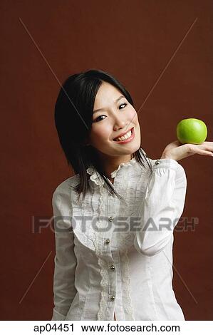 Woman holding green apple in palm of hand View Large Photo Image Stock Image - Woman holding green apple in palm of hand. Fotosearch