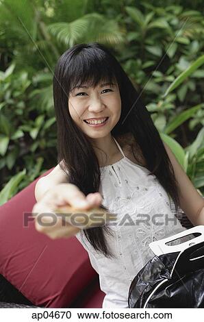 Stock Image - Woman holding out credit card. Fotosearch