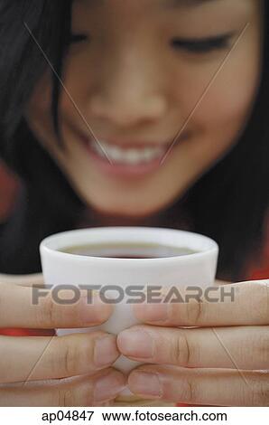 Stock Photo - Woman holding teacup. Fotosearch