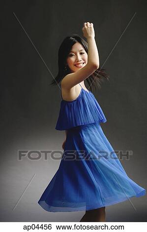 Woman in blue dress, spinning View Large Photo Image Stock Photograph - Woman in blue dress, spinning. Fotosearch