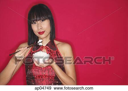 Woman in cheongsam holding bowl of rice View Large Photo Image Stock Photo - Woman in cheongsam holding bowl of rice. Fotosearch