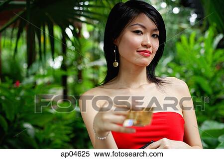Woman in red dress, holding credit card View Large Photo Image Stock Photography - Woman in red dress, holding credit card. Fotosearch