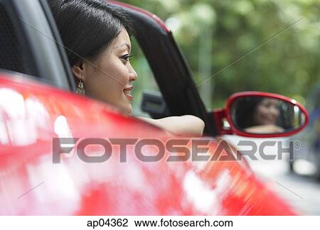 Woman in red sports car View Large Photo Image Stock Image - Woman in red sports car. Fotosearch