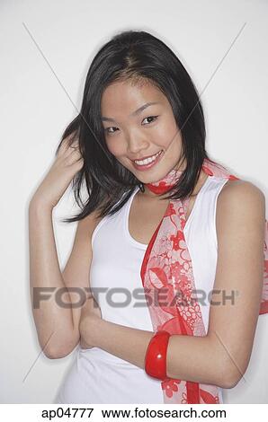 Stock Photo - Woman in white top and scarf against white background. Fotosearch