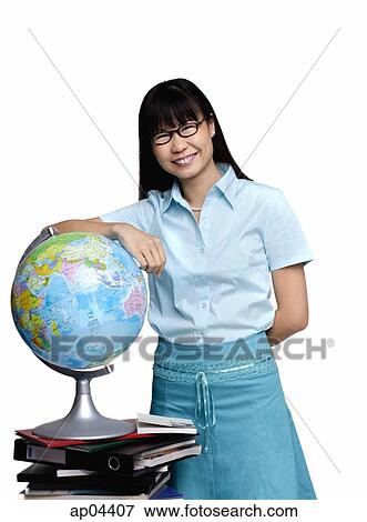Woman leaning on globe, smiling at camera View Large Photo Image Stock Photo - Woman leaning on globe, smiling at camera. Fotosearch