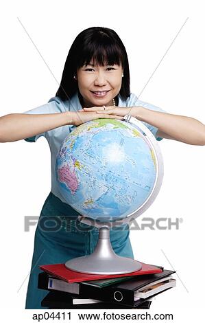Woman leaning on globe, smiling View Large Photo Image Stock Image - Woman leaning on globe, smiling. Fotosearch