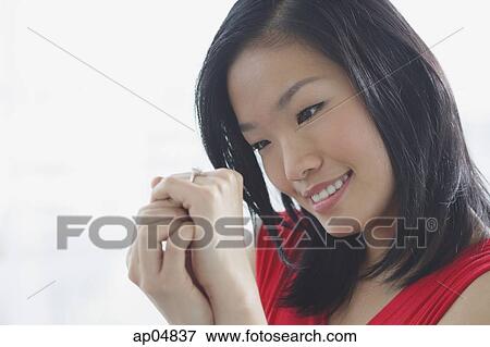 Woman looking at ring on her finger View Large Photo Image Stock Photo - Woman looking at ring on her finger. Fotosearch