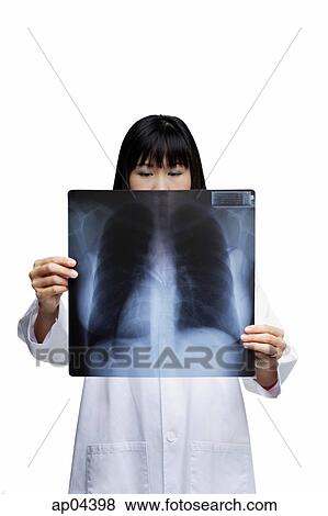 Woman looking at X-ray, obscured face View Large Photo Image Stock Photo - Woman looking at X-ray, obscured face. Fotosearch