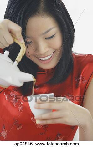 Woman pouring tea View Large Photo Image Stock Photograph - Woman pouring tea. Fotosearch