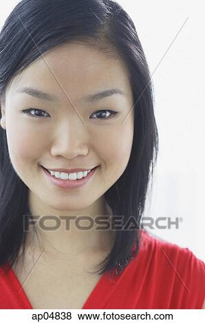 Stock Photo - Woman smiling at camera, head shot. Fotosearch