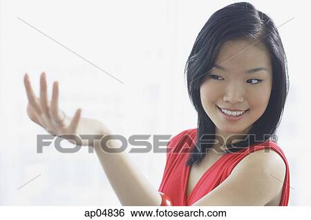Woman smiling, looking at ring on her finger View Large Photo Image Stock Photograph - Woman smiling, looking at ring on her finger. Fotosearch