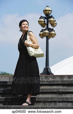 Woman walking down steps View Large Photo Image Stock Image - Woman walking down steps. Fotosearch