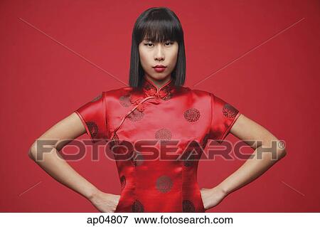 Woman wearing cheongsam, hands on hip, looking at camera View Large Photo Image Stock Photo - Woman wearing cheongsam, hands on hip, looking at camera. Fotosearch