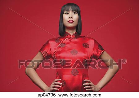 Stock Photograph - Woman wearing cheongsam, hands on hip. Fotosearch