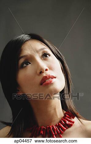 Woman wearing chunky necklace, pensive expression View Large Photo Image Stock Photo - Woman wearing chunky necklace, pensive expression. Fotosearch