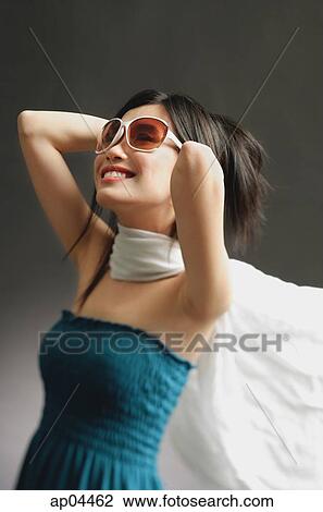 Woman wearing large sunglasses, tube top and scarf, smiling View Large Photo Image Stock Image - Woman wearing large sunglasses, tube top and scarf, smiling. Fotosearch