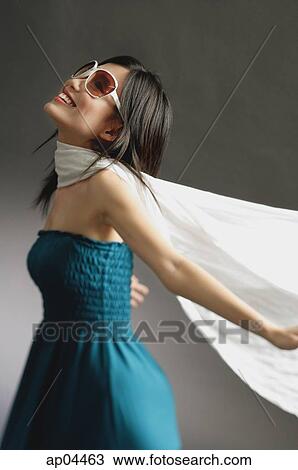 Woman wearing large sunglasses, tube top and scarf, arms outstretched View Large Photo Image Stock Image - Woman wearing large sunglasses, tube top and scarf, arms outstretched. Fotosearch