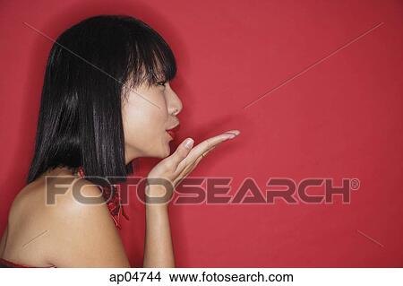 Woman with bob haircut, blowing a kiss, side view View Large Photo Image Picture - Woman with bob haircut, blowing a kiss, side view. Fotosearch
