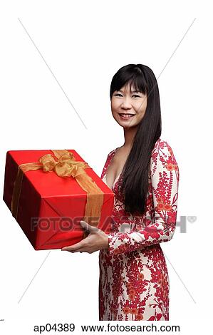 Woman with long straight hair, holding gift wrapped box View Large Photo Image Stock Photo - Woman with long straight hair, holding gift wrapped box. Fotosearch
